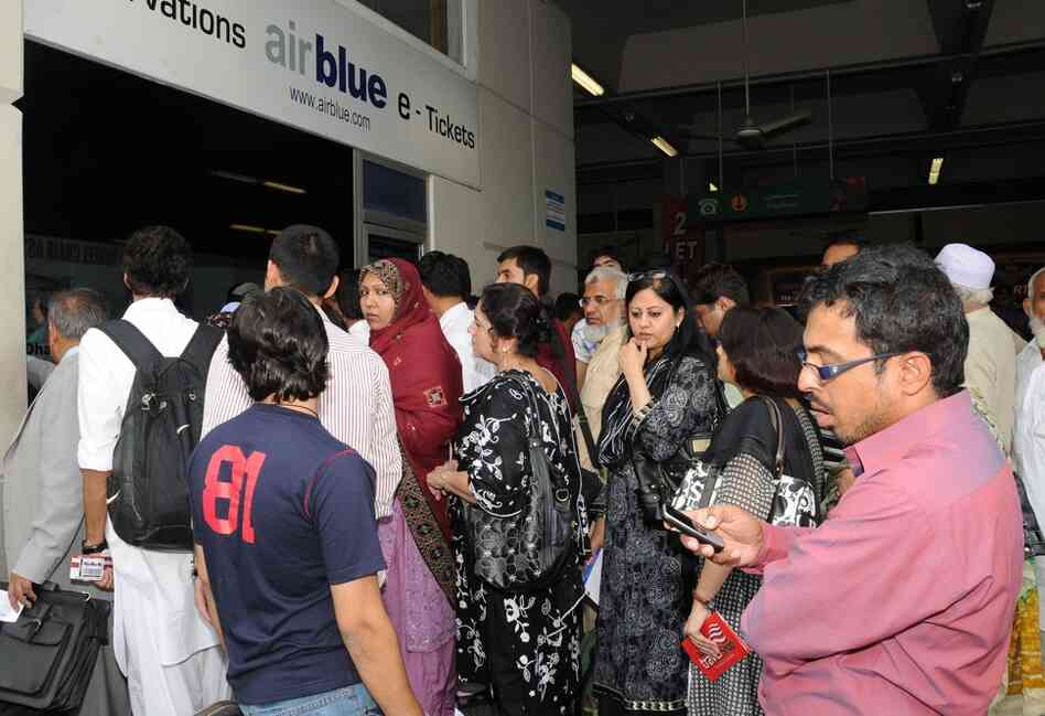 Family members gather at the Airblue counter in Islamabad to try to get details about their relatives. 