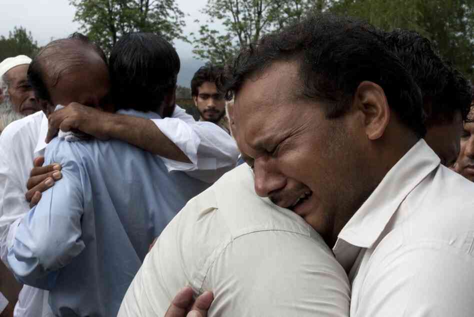 Relatives of the passengers mourn their deaths outside a local hospital in Islamabad. 