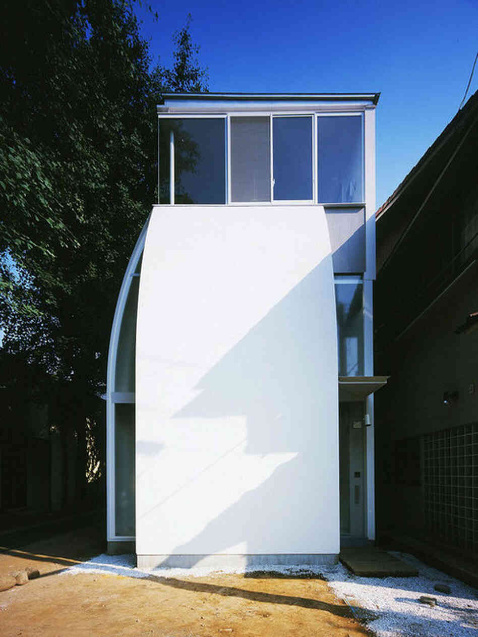 Built for a couple, the "Penguin House" micro home has windows situated to frame surrounding keyaki trees.