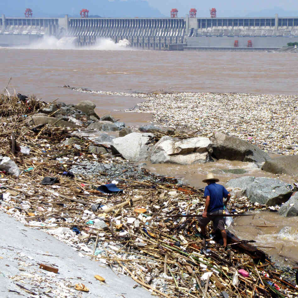 Two workers clean up trash along the ban Two workers clean up trash along the ban