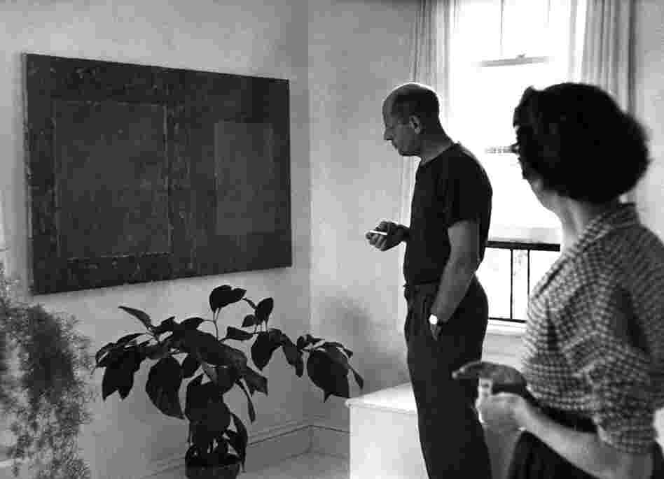 Pollock and Lee Krasner in their bedroom, looking at an untitled 1950 painting by Krasner, August 1953