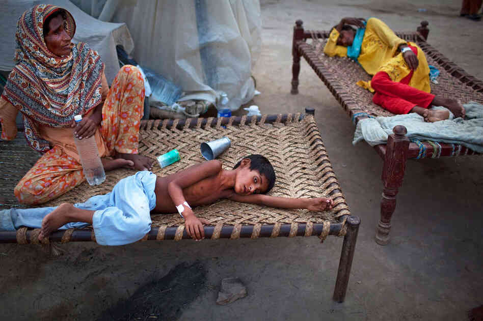 Yakub, 8, lies next to his mother Aug. 22 at a makeshift hospital in Muzaffargarh in Punjab, where he's receiving treatment for diarrhea. The U.N. warned that up to 3.5 million children are at risk from water-borne diseases and feared a "second wave" of deaths from disease after cholera was confirmed in some patients. 