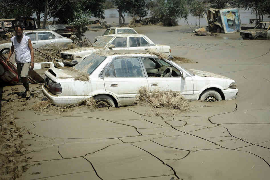 Dried mud surrounds cars Aug. 5 in Nowshera.  