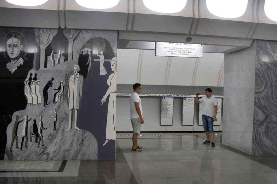 Waiting for a train at Dostoevskaya means time to gaze at murals depicting scenes from Dostoevsky's book The Idiot – or to pose for a friend to take a picture.