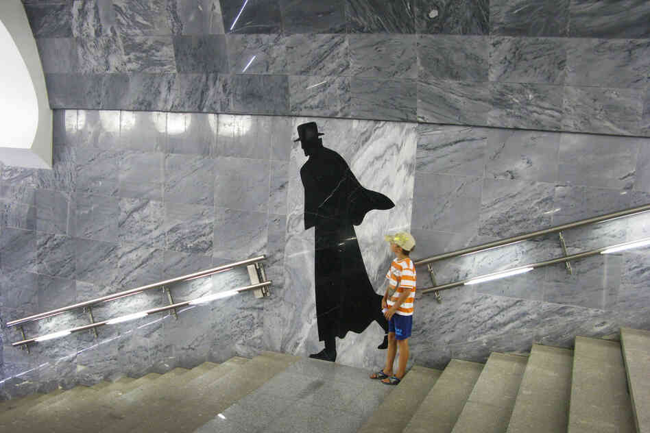 Subway riders not in a rush often pause for a look or a snapshot of the station's gloomy artwork.