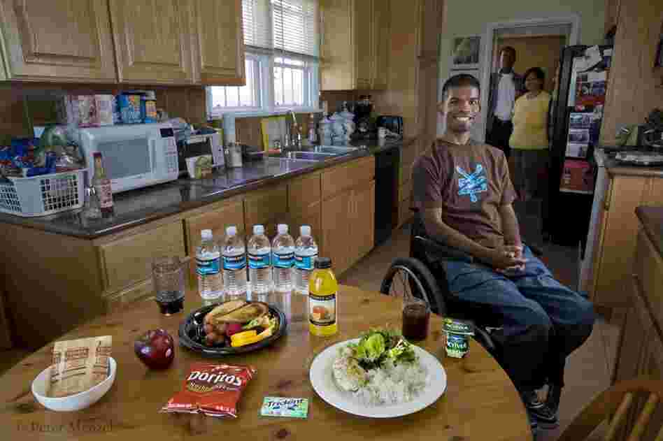 Felipe Adams, a 30-year-old Iraq war veteran with his parents and a typical day of food at their home in Inglewood, Calif. He is 30 years old; 5 food 10 and weighs 135 pounds, and his typical day of calories added up to 2100. Adams was paralyzed by a sniper's bullet while serving in Baghdad, Iraq. His diet includes oatmeal, a chicken sandwich, yogurt, chicken breast and yogurt.