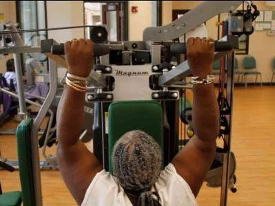 Woman exercises at fitness center for seniors Woman exercises at fitness center for seniors