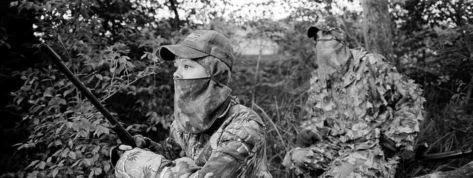 Amanda Svoboda watches for wild turkeys with her father, John.