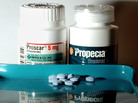 Bottles of the drugs Proscar and Propecia. Bottles of the drugs Proscar and Propecia.