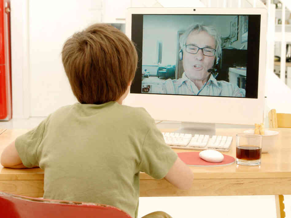A child videochats with his grandfather. A child videochats with his grandfather.