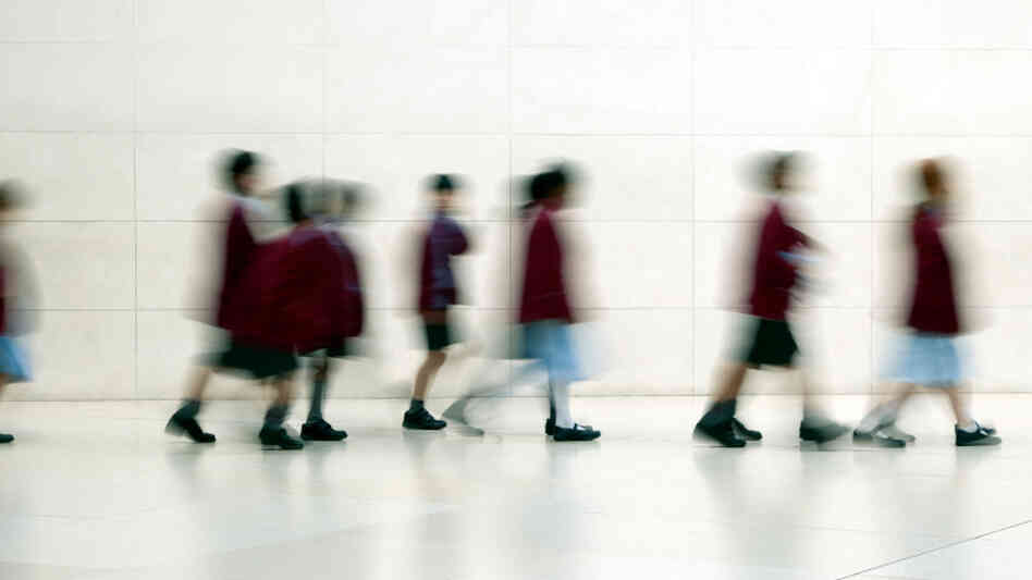 Kids walk down a hall. Kids walk down a hall.