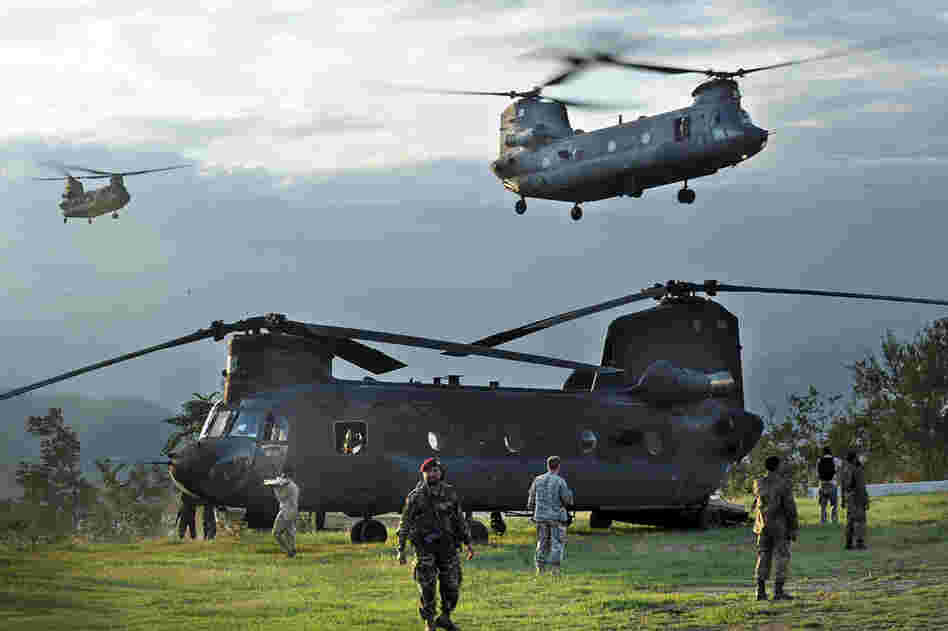 U.S. Chinook helicopters carrying flood survivors arrive Aug. 9 in Khwazakhela in the Swat Valley. As anger mounts among survivors, the Pakistani government and U.N. officials have appealed for more urgent relief efforts. 