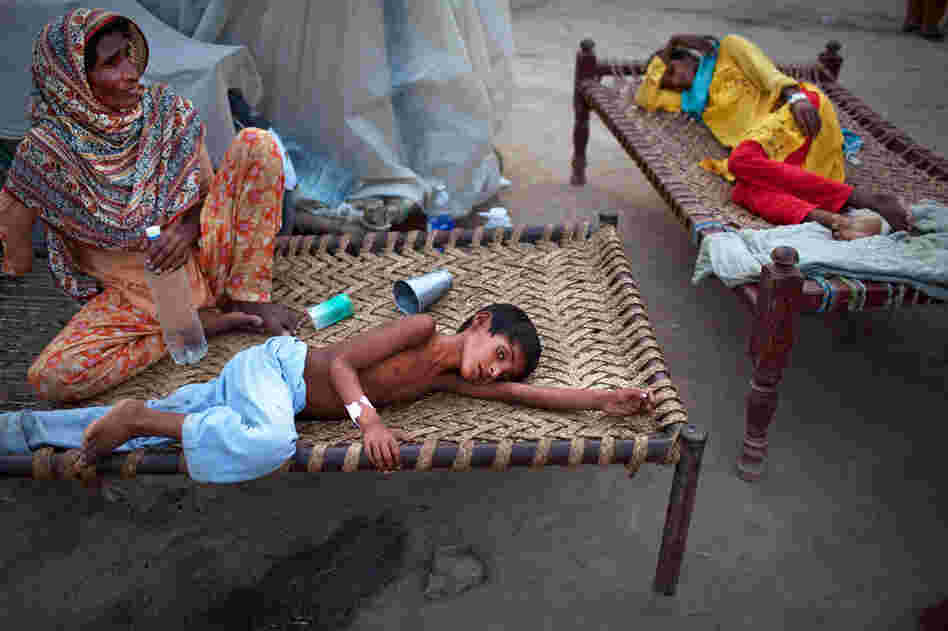 Yakub, 8, lies next to his mother Aug. 22 at a makeshift hospital in Muzaffargarh in Punjab, where he's receiving treatment for diarrhea. The U.N. warned that up to 3.5 million children are at risk from water-borne diseases and feared a "second wave" of deaths from disease after cholera was confirmed in some patients. 