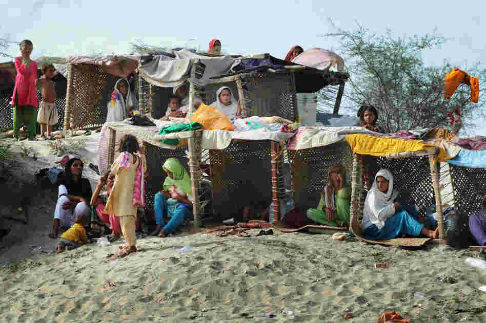 Pakistanis displaced by floods take shelter in temporary tents made with charpoys (bedsteads) near a makeshift camp in Baseera in Punjab province on Aug. 26. The United Nations warned that 800,000 people in desperate need of aid had been cut off by the deluge across the country and appealed for more helicopters to deliver supplies to those people reachable only by air. 