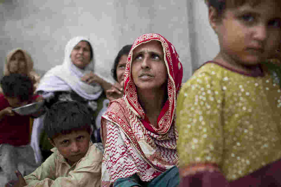 Bibi Gul (center) sits with her family in a school transformed into a camp for displaced people on the outskirts of Nowshera. The monsoon swallowed up Gul's house and two of her children. With no news of her son and daughter days later, she is distraught. 