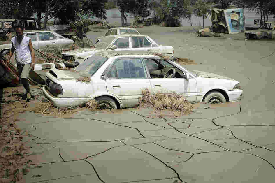 Dried mud surrounds cars Aug. 5 in Nowshera.  