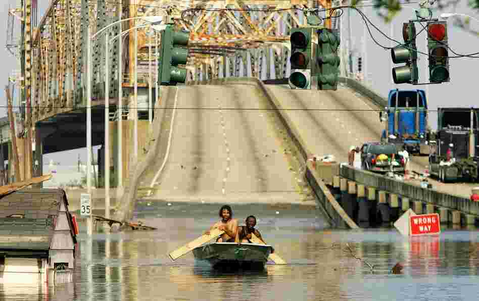Two men paddle in high water after Hurricane Katrina devastated the area on Aug. 31, 2005. 