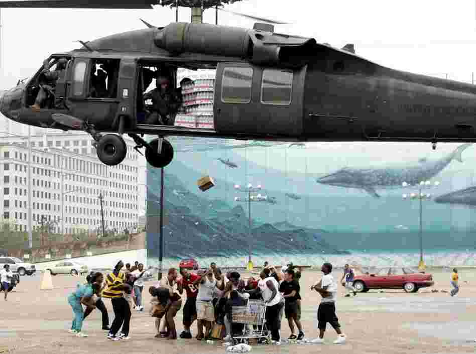 A military helicopter makes a food and water drop to flood victims near the convention center on Sept. 1, 2005. Officials called for a mandatory evacuation of the city, but many residents remained in the city and had to be rescued from flooded homes and hotels. 