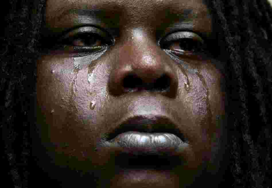 Leonard Thomas, 23, cries after a SWAT team burst into the flooded home he and his family were living in New Orleans on Sept. 5, 2005. Neighbors had reported that they were squatting in the house in the wake of Hurricane Katrina but the authorities left after his family proved they owned the house. 