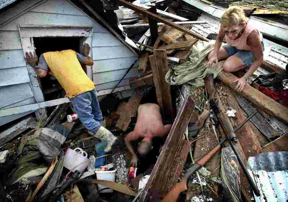 Residents dig through the rubble of what is left of their home in Biloxi, Miss, on Aug. 31, 2005, following Hurricane Katrina. 