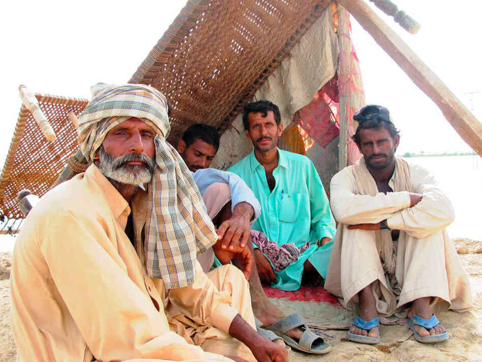 Zurif Kar, Hafiz Ullah, Abdul Majid and Sherun Kardarbush take shelter on top of the levee. Zurif Kar, Hafiz Ullah, Abdul Majid and Sherun Kardarbush take shelter on top of the levee.