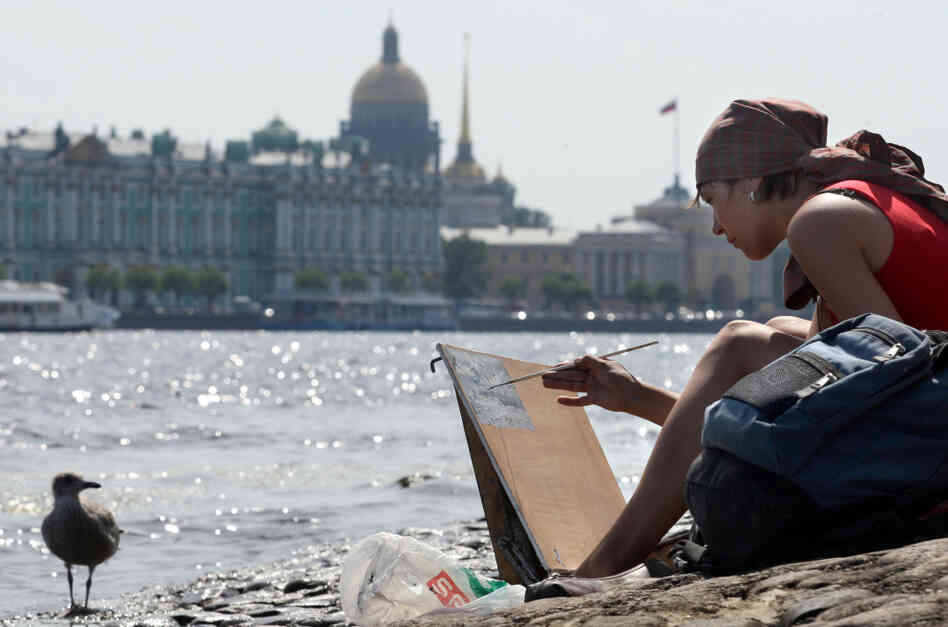 A Russian woman paints on banks of the Neva River. A Russian woman paints on banks of the Neva River.