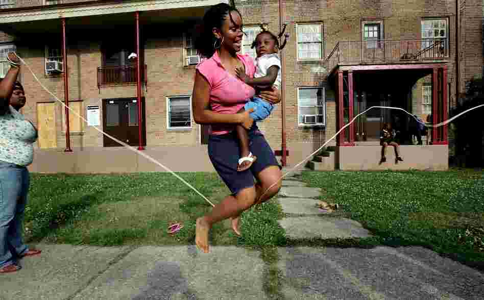 B.W. Cooper housing project resident Leianne LaRoche holds niece Destiny Herbert, 2, as they jump rope using a phone cable in front of their apartment June 6, 2007, in New Orleans. Before Hurricane Katrina, B.W. Cooper held about 1,000 families and was the city's largest housing project, but in 2007 it was more than 80 percent empty.