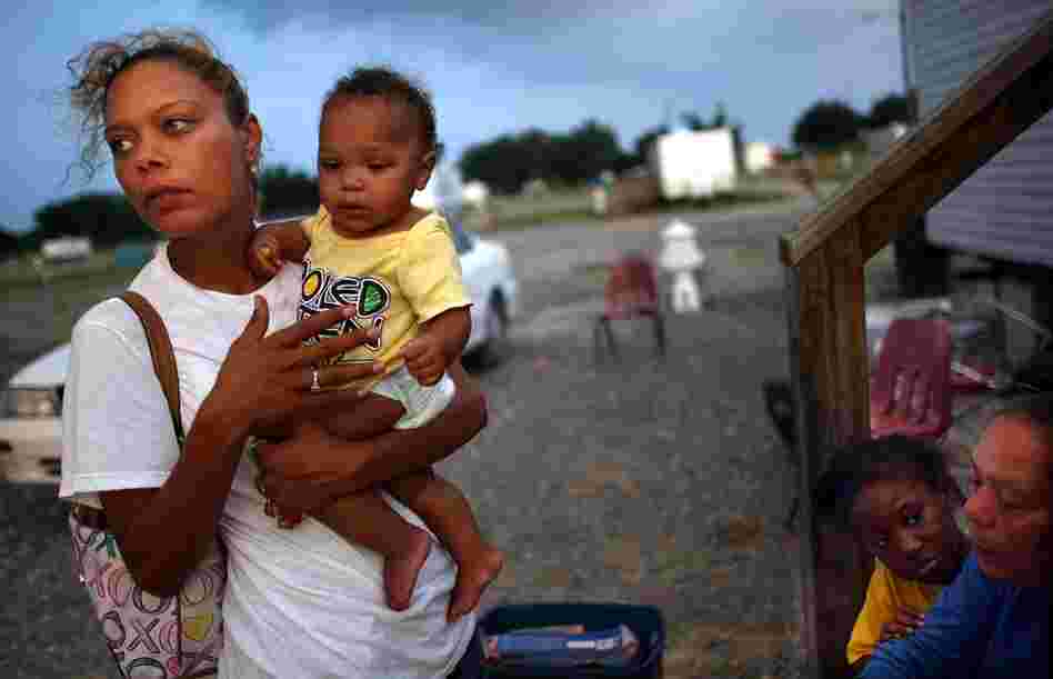 Shelly Phillips holds niece Kimmore Barthelemy in the FEMA Diamond travel trailer park May 26, 2008, in Port Sulphur, La. Phillips lost her home and job in Hurricane Katrina and is raising four children.