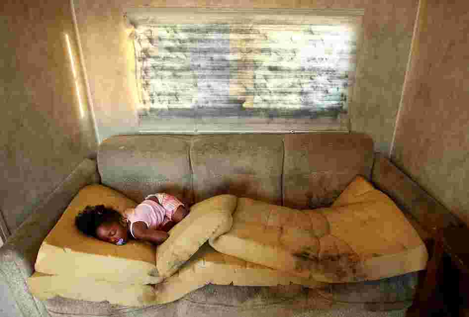 Kailah Smith, 18 months, sleeps on a moldy couch caused by rain leaks in her parents' trailer in the FEMA Diamond trailer park just before the family moved to an apartment May 28, 2008, in Port Sulphur, La. Smith's parents had to hospitalize her four times with bronchitis since moving into the trailer, and say they are sure the trailer was to blame for her illnesses.