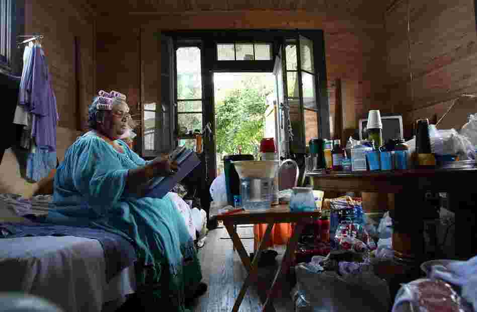 Retired seamstress Rita Gillett, 63, sits in her damaged home in the Lower Ninth Ward, where she lives with her husband Hazzert, on Aug. 24, 2007. The couple still lived without electricity or gas because they hadn't been able to secure government assistance to pay for the repairs.