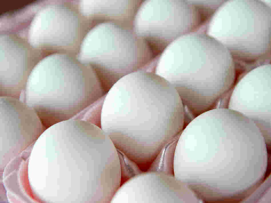 Eggs sit in an egg carton Eggs sit in an egg carton