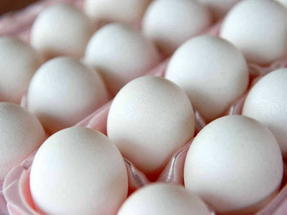 Eggs sit in an egg carton Eggs sit in an egg carton