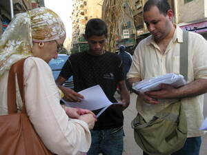 Ahmed Nasser (right) and Shahinaz Abdel-Wahab hand out petitions for better governance in Cairo.