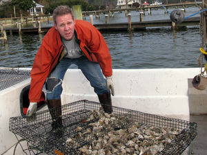 Ryan Croxton's grandfather's oyster operation dragged dredges across oyster reefs, ripping up the habitat. Croxton grows oysters in cages for the half-shell market.