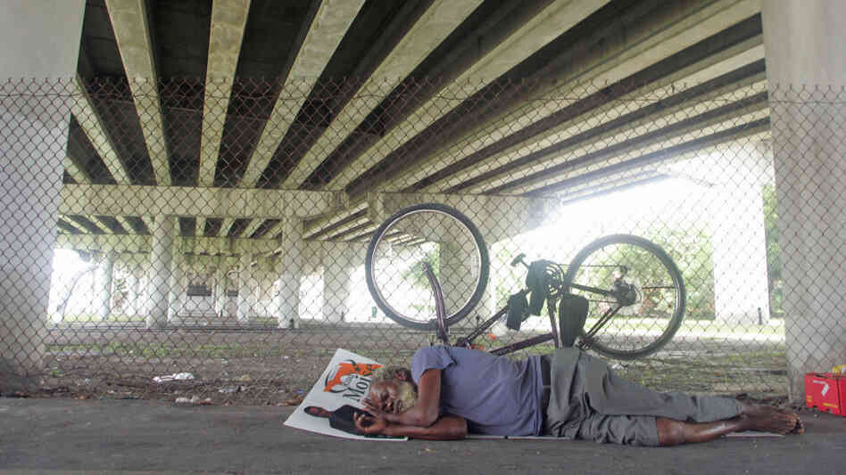 Ray McNair rests under I-95 in Overtown. Tom Ervin For NPR Ray McNair rests under I-95 in Overtown. Tom Ervin For NPR