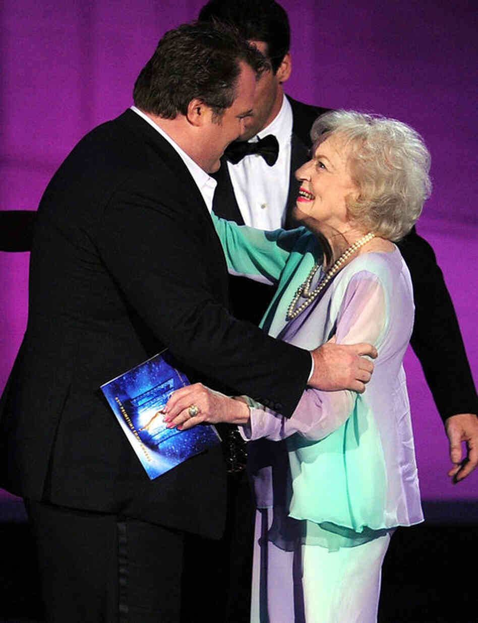 Actor Eric Stonestreet accepts the Outstanding Supporting Actor in a Comedy Series award for Modern Family from actress Betty White. 