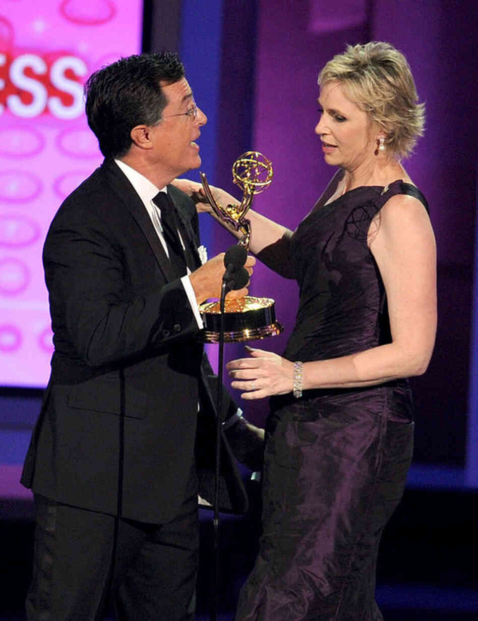 Actress Jane Lynch, right, accepts the Outstanding Supporting Actress in a Comedy Series award for Glee from Stephen Colbert. 