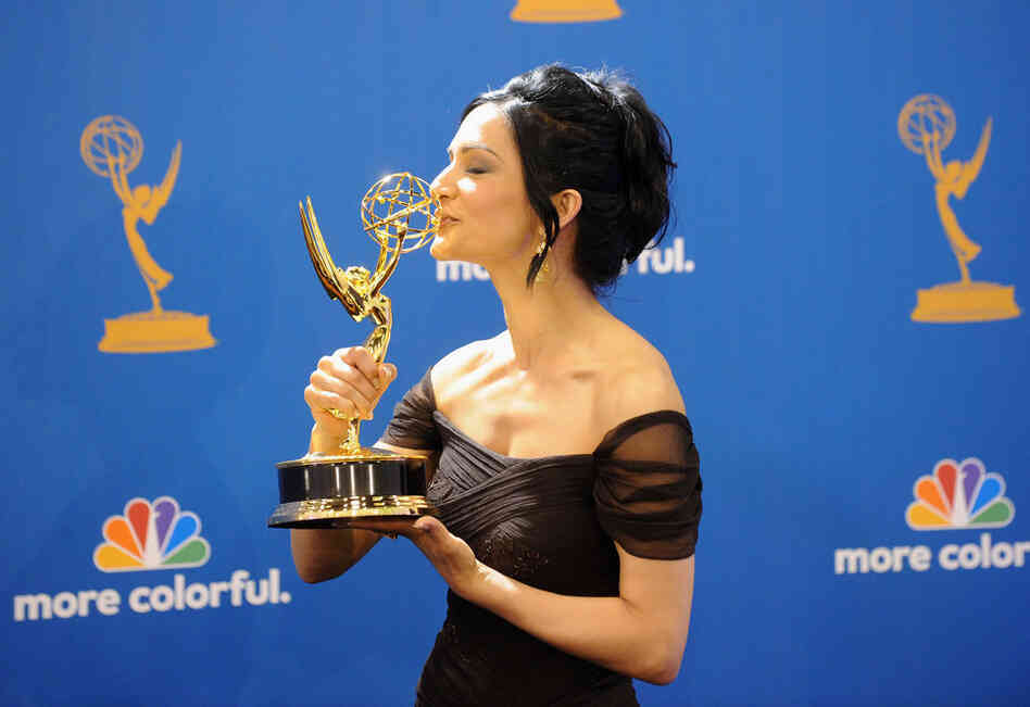Actress Archie Panjabi, winner of the Outstanding Supporting Actress in a Drama Series Award for The Good Wife kisses her trophy.  