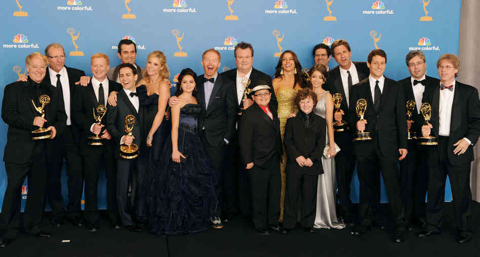 Cast and crew of Modern Family, winners of the Outstanding Comedy Series Award pose in the press room at the Emmy Awards.  