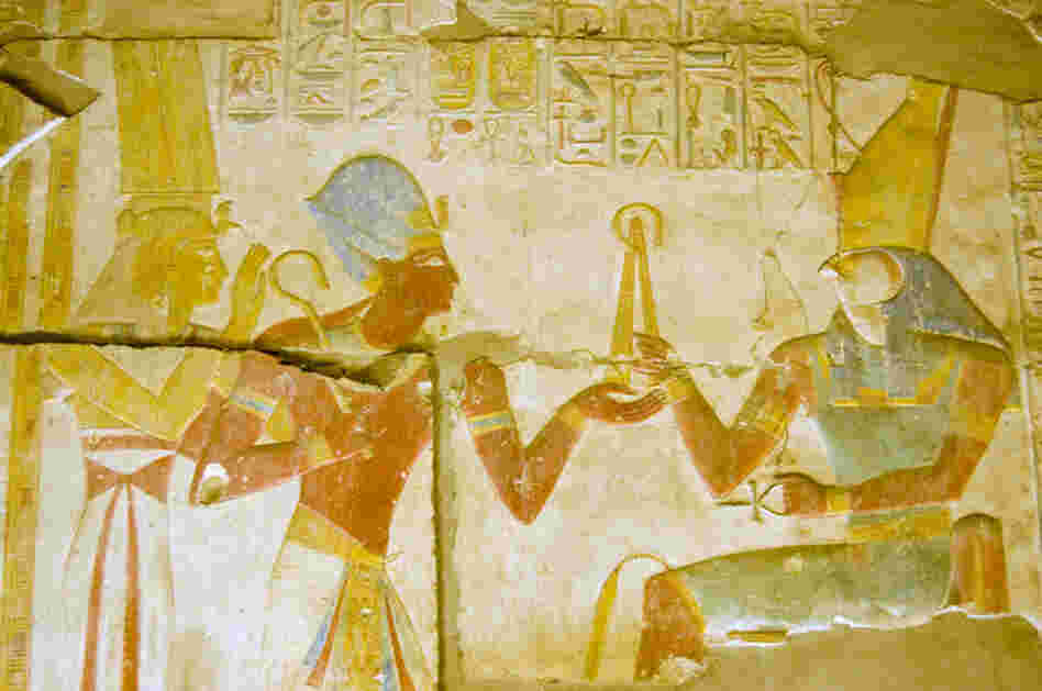 Ancient Egyptian Pharaoh Seti I with goddess Isis and god Horus.  