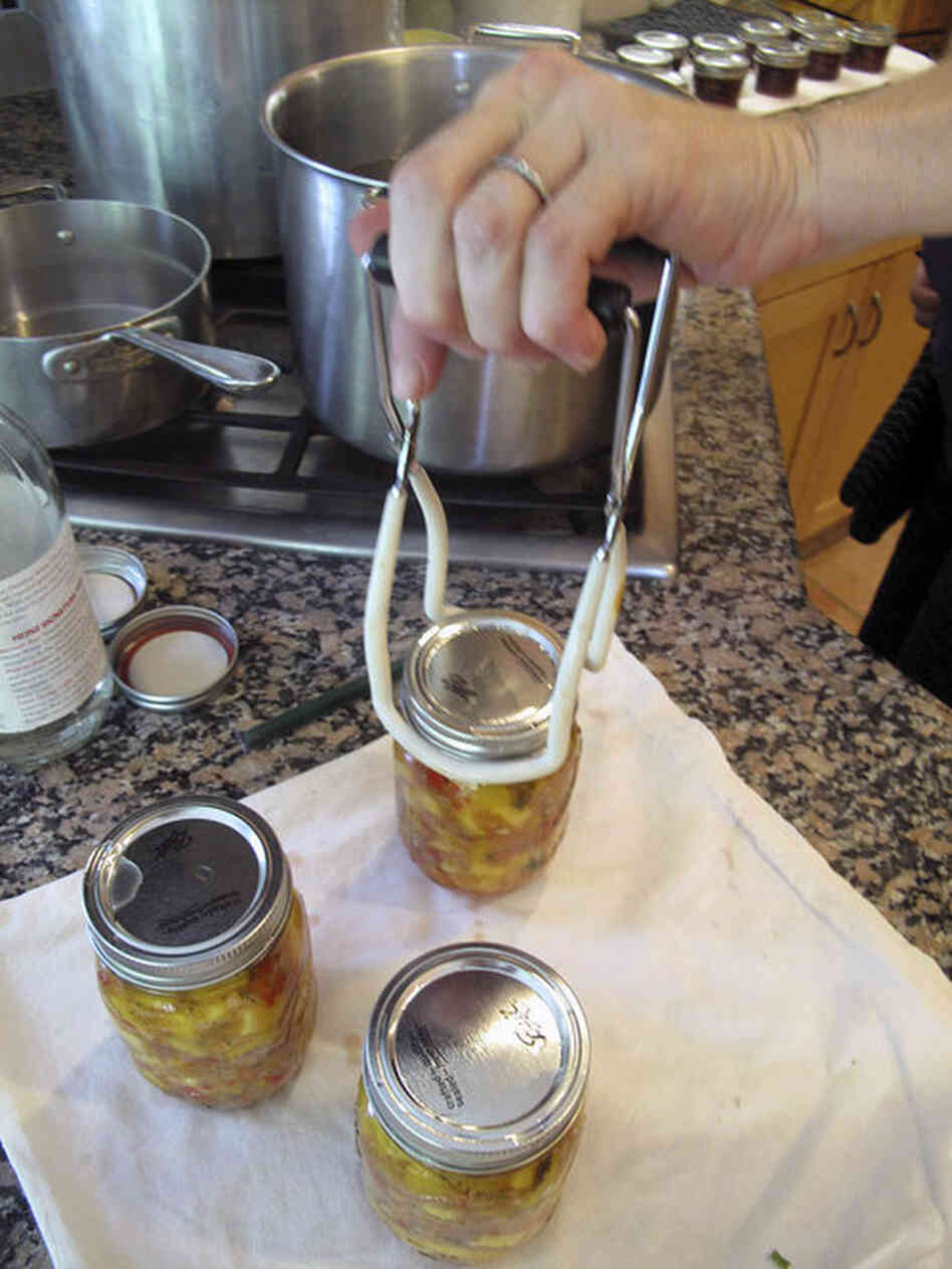Barrow uses a jar lifter on a batch of her peach salsa. "People now start putting their orders in for Christmas," Barrow says. "You know, you think, 'Oh, I'll just give people a few jars of jam.' And I hear, 'I really like that salsa!'"