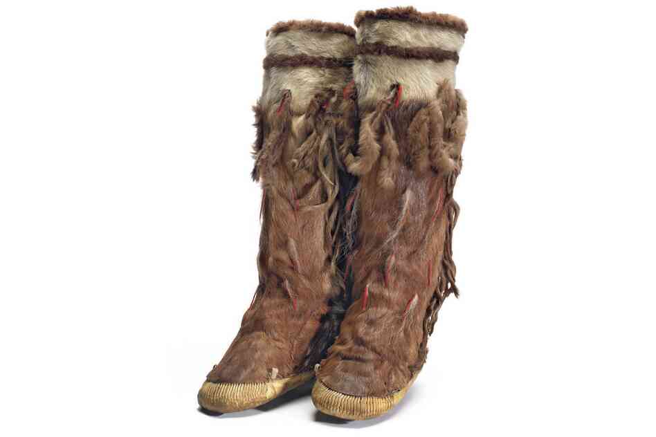 Yupik boots. A woman's tasseled winter boots made from caribou leg skins. The bands on top are white caribou belly with stripes of either beaver or bear. One pair of boots required all four of the animal's limbs.