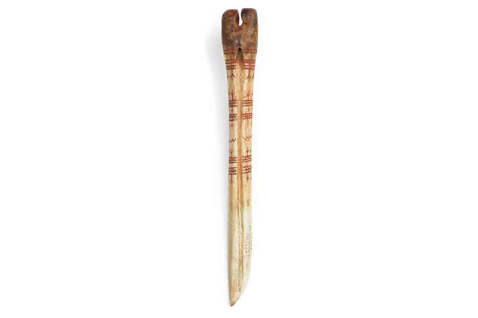 Athabascan bark-stripping tool. A sharpened caribou leg bone decorated with raven-foot designs was used for peeling bark from birch trees.