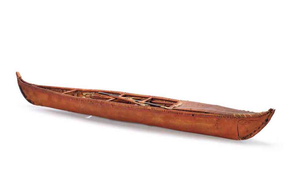 A Yukon River canoe equipped with a fishing spear. Athabascan bark canoes were light, fast and notoriously tippy. They were paddled, poled or pulled along by dogs on the river bank.