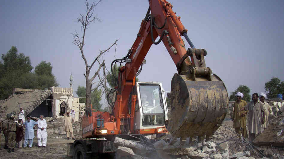 Workers clear rubble at the site of a suicide bombing at a police station in Lakki Marwat, Pakistan. Workers clear rubble at the site of a suicide bombing at a police station in Lakki Marwat, Pakistan.
