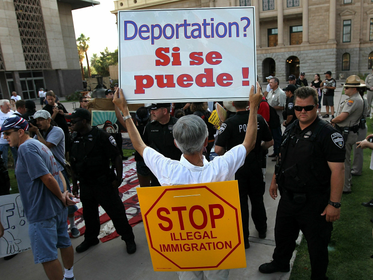 Supporters and opponents of Arizona's immigration law rallied in Phoenix on July 31. Many demonstrators carried signs to show their feelings.