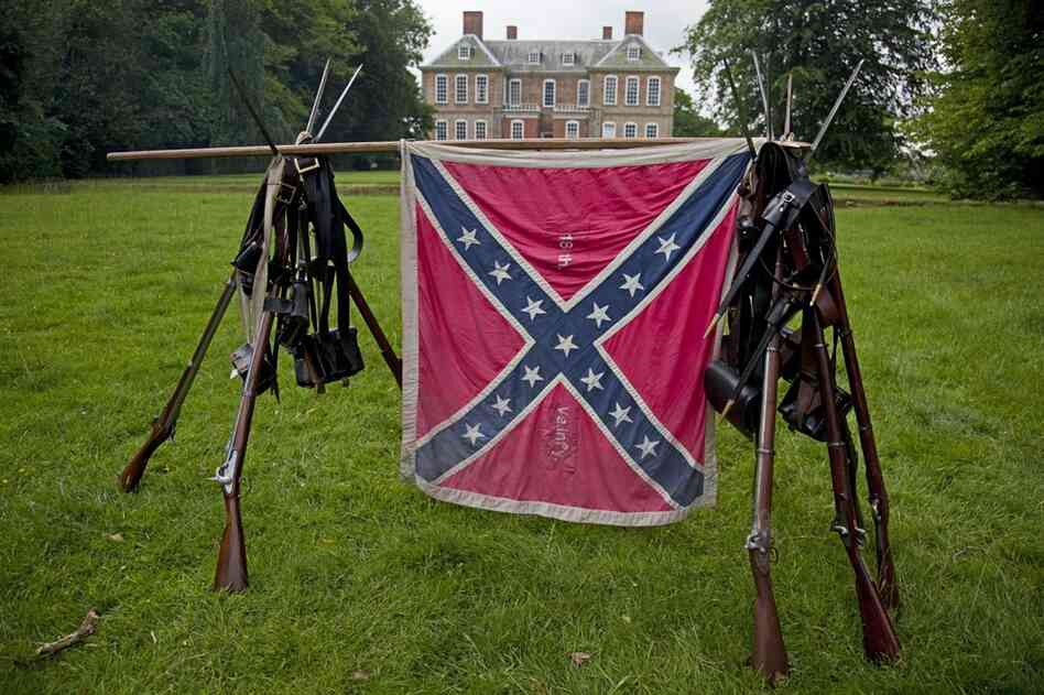 The Confederate flag and arms of the 18th Virginia Infantry stand in a field behind the stately Stanford Hall. The estate has been owned by descendants of 2nd Baronet Sir Roger Cave since construction began in the 1690s.