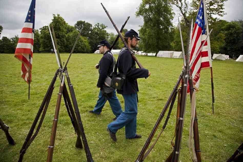 118th Pennsylvania Infantry Pvt. Nathan Swinney (left) and 18th Missouri Infantry Pvt. Philip Alderton guard stacked arms.