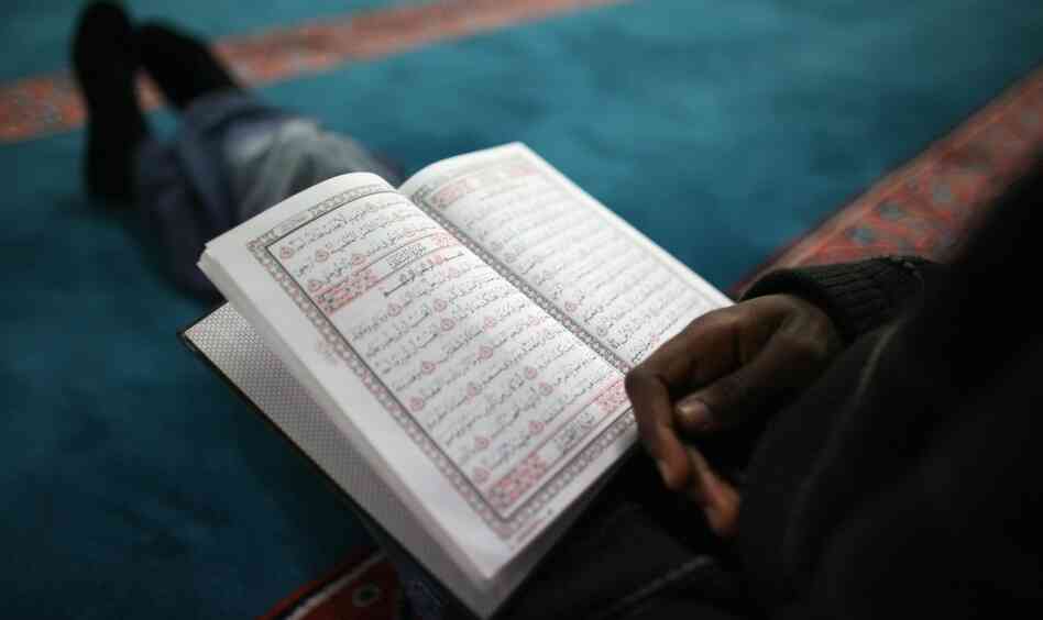 A man reads the Quran in London before the Ramadan evening meal. A man reads the Quran in London before the Ramadan evening meal.