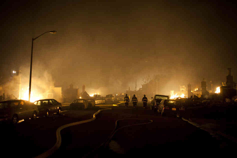 Firefighters walk through smoke during a massive fire in a residential neighborhood Thursday in San Bruno, Calif. A ruptured natural gas line sparked a massive explosion in a neighborhood near San Francisco International Airport. 